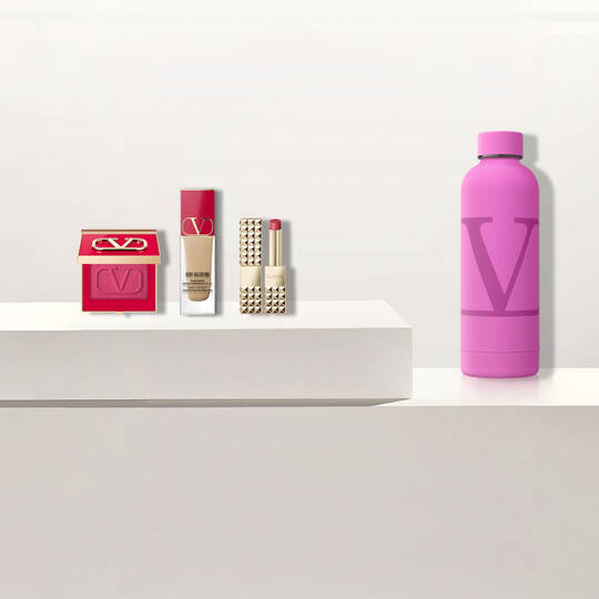 Produits de beaute Valentino et une bouteille d'eau rose avec le logo "V"