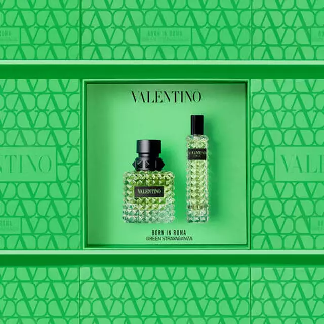 A vibrant green box featuring the Valentino "Born in Roma Green Stravaganza" fragrance, showcasing a textured bottle and a smaller vial, all set against a matching patterned background.