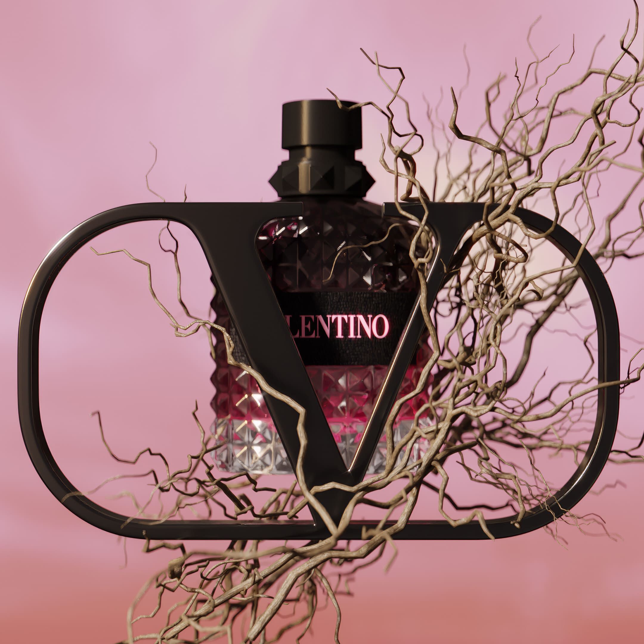 A stylish perfume bottle with a geometric shape, featuring a black cap and a pink label that reads "VALENTINO," is framed by abstract, twisted branches against a soft pink background.