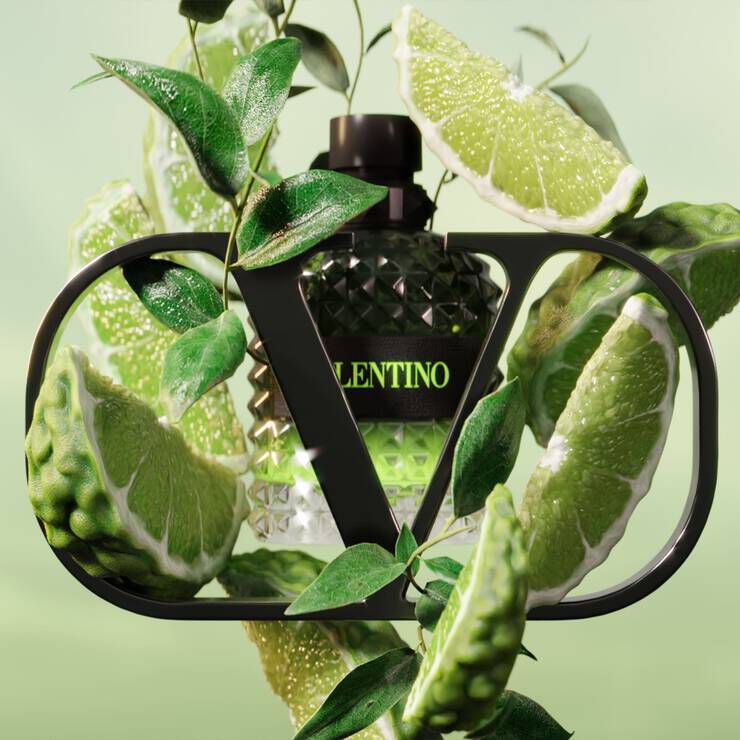 A green background featuring a bottle of Valentino perfume surrounded by vibrant lime slices and lush green leaves, framed by a stylish black "V" logo.