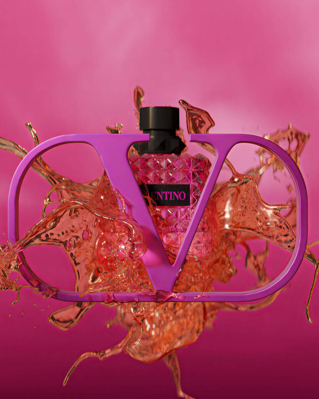 A vibrant pink perfume bottle in the shape of a "V," surrounded by splashes of rose-colored liquid against a bright pink background.